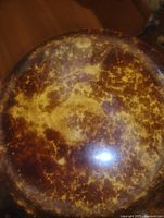 Top view of exterior base showing mottled brown and tan glaze pattern and wear