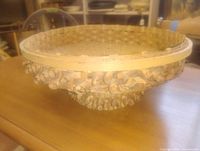 Side view showing frilled curled wicker detailing and shallow bowl shape