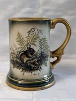Front view of ceramic tankard mug showing full artwork and handle
