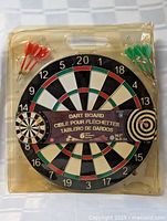 Front view of sealed dart board showing diameter and darts