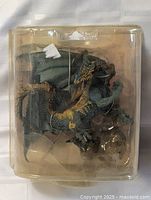 Front view of dragon action figure in sealed clamshell packaging