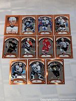 Full set of 12 copper foil hockey cards displayed in grid