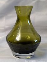 Front view of olive green glass vase with clear base
