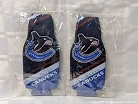 Front view of both koozies in packaging showing logos and text