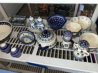 Full group of Polish Boleslawiec pieces on shelf