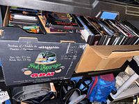 Two boxes filled with DVDs on shelf