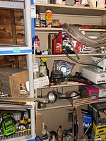 Full shelving showing chargers, oils, suet, fire starters, charcoal starter