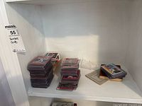 Stacks of sleeved cards and loose cards on shelf