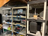 Two beige and one black/white plastic shelving units shown together