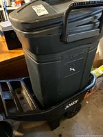 Rubbermaid trash barrel sitting inside Ames garden cart