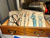 Drawer holding assorted Simplicity and Advance pattern envelopes with scissors