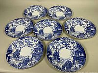 All seven Royal Crown Derby Mikado Blue plates displayed