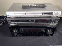Stack showing Pioneer DV-285 DVD player with remote, Electrohome HVR-D51 VCR, Pioneer AV receiver