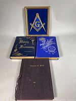 Lot overview showing framed emblem and three books