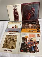 Group shot of nine vinyl albums with visible covers