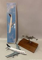Air Canada model airplane with original box and metal seaplane model on wood base