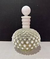 Front view of Fenton hobnail opalescent perfume bottle with stopper