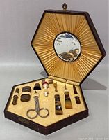 Full view of open hexagonal case, mirror, and tools