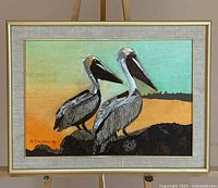 Front view of framed 3D lighted pelican artwork on easel