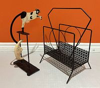 Magazine rack and balancing sculpture side by side, full view