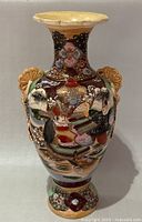 Front view showing samurai scene, form, handles, rim and base