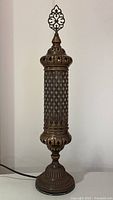 Full view of brass-tone pierced metal Turkish Moroccan table lamp, showing overall design and height