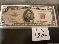 Full view of 1953 A $5 red seal note in sleeve showing serial number and Lincoln portrait