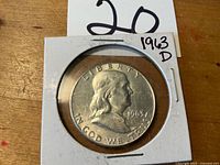 Obverse of coin in holder showing date and mint mark