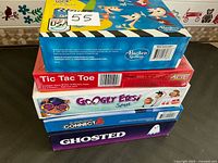 Stack of five sealed board game boxes