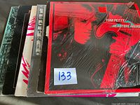 Stack of five vinyl albums showing spines and partial covers