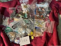 overview of multiple bags of costume jewelry on red fabric