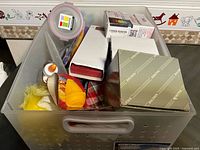 Overview of plastic bin with assorted items