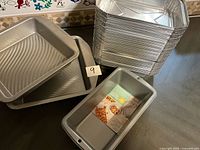 Stack of aluminum tins with three Wilton pans visible