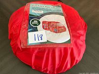 Full view of red carry bag with product sheet showing fire truck play tent