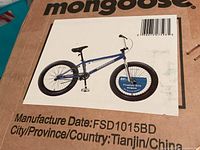 Box with Mongoose branding and picture of blue BMX bike