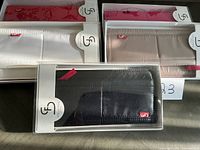 Group shot of five boxed Stella & Fritz wallets showing multiple colours