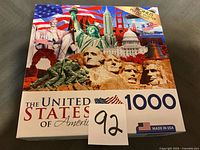 Front of sealed puzzle box showing landmark collage and piece count