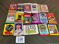 Overall view of 15 sealed trading card packs laid out in three rows