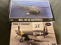 Both model kits showing Bell UH-1B Hueycobra sealed box on top and F4U-1 Corsair box below