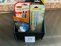 First side of caddy with BIC pens, pencils, Wite-Out, Pilot highlighters visible