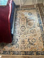 Rug on floor beside bed showing overall design and colors