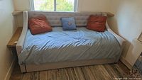 Daybed fully assembled with pillows and sheet