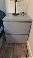 Full view of grey nightstand with two drawers