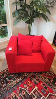 front view of red armchair with pillow
