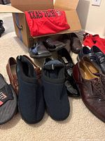 Group shot of nine pairs of shoes and Nike Texas Tech T-shirt