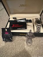 Overall lot: Gruen watch in box with paperwork, Paparazzi earrings, signed pendant