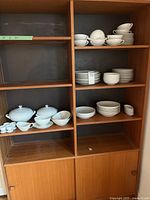 Entire cabinet view showing majority of dinnerware pieces