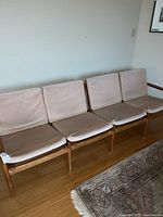 Full view of four-seat teak sofa with cushions