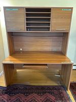 Full view of desk with attached hutch showing shelves and cabinet