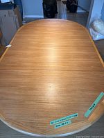 Top view of oval teak table surface showing grain and shape